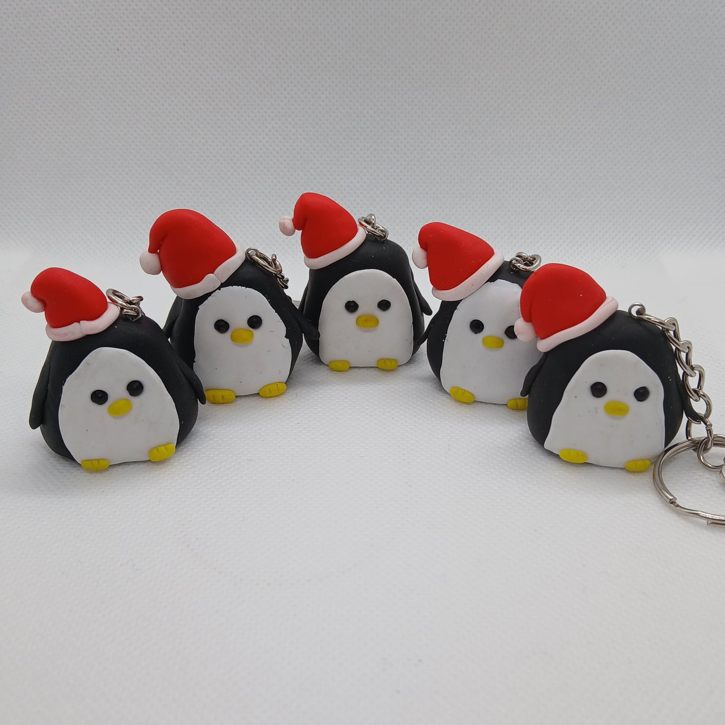 penguin in a Santa hat polymer clay keyring